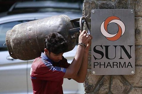 A man carrying a gas cylinder walks out of the research and development centre of Sun Pharmaceutical Industries Ltd in Mumbai May 29, 2014.|REUTERS