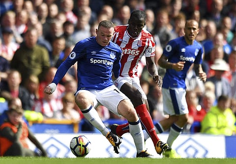 Everton's Wayne Rooney, left, and Stoke City's Kurt Zouma in action during the English Premier League soccer match at Goodison Park, Liverpool. | AP