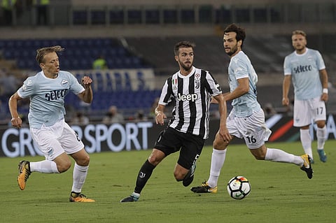Juventus' Miralem Panic, center, dribbles past Lazio's Lucas Leiva, left, and Lazio's Marco Parolo during the Italian Super Cup final match between Lazio and Juventus at Rome's Olympic stadium. | AP