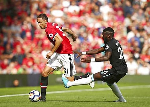 Manchester United's Nemanja Matic, left, gets past West Ham United's Arthur Masuaku during the English Premier League soccer match between Manchester United and West Ham United. | AP