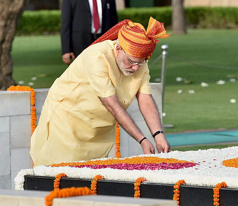 Prime Minister Narendra Modi paying floral tributes at the Samadhi of Mahatma Gandhi at Rajghat, after addressing the nation on Independence day. | AP