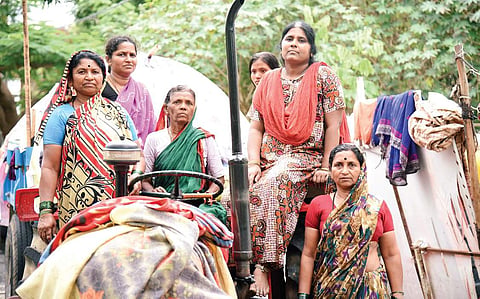 Chitra (second from right) with her neighbours who took shelter from the flood on a parked tractor for nearly seven hours, in ST Bed Layout in Koramangala on Tuesday | Nagaraja Gadekal