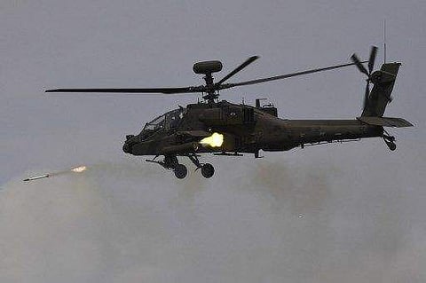 This picture taken on April 21, 2017 shows a South Korean AH-64E Apache helicopter firing rockets during a media day presentation of a joint live firing drill between South Korea and the US at the Seungjin Fire Training Field in Pocheon, 65 kms northeast 