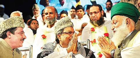 Chamarajpet MLA Zameer Ahmed Khan and Chief Minister Siddaramaiah at programme to felicitate Haj pilgrims at Town hall in Bengaluru on Friday | NAGESH POLALI