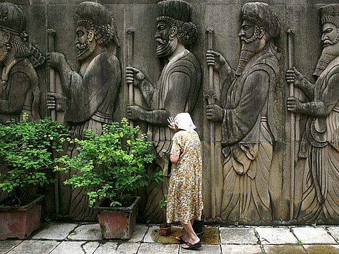 A Parsi women praying near a fire temple at Tardeo in Mumbai, during Navroz, the Parsi New Year  (Photo | AP)