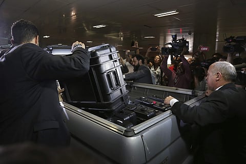 FILE - In this Oct. 21, 2016 file photo, federal police put items seized from the Federal Senate Legislative Police headquarters into a vehicle as part of an investigation into the Car Wash operation in Brasilia, Brazil. Brazil’s Attorney-General’s office