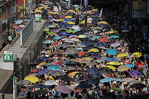 Demonstrators march in protest of the jailing of student leaders Joshua Wong, Nathan Law and Alex Chow, who were imprisoned for their participation of the 2014 pro-democracy Umbrella Movement, also known as 'Occupy Central' protests, in Hong Kong China Au