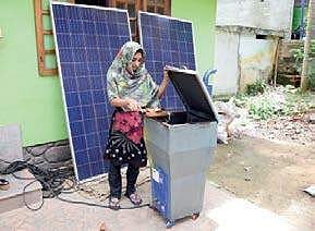 Fathima,daughter of Shanavas Sainulabdeen, disposing of waste in the solar incinerator developed by her father |B P Deepu