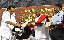 Stalin being handed over a copy of a book on Thanthai Periyan during the  conference in the city on Friday | ashwin prasath