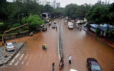 A road covered with mud after the rains water receded in Mumbai on Wednesday. | PTI