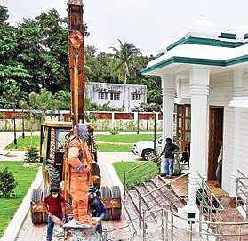 A crane deposits the statue of Sivaji Ganesan outside the memorial hall on Durgabhai Deshmukh Road on Thursday after uprooting it from Kamarajar Salai  | p jawahar