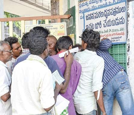 People stand in queue for birth certificates at GGH in Guntur. (Left) Patients’ attendants waiting at the corridor causing inconvenience to patients  | P ravindrababu