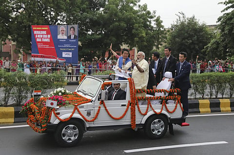 Breaking away from official protocol, Prime Minister Narendra Modi on Wednesday proceeded on a roadshow with his Japanese counterpart Shinzo Abe soon after the latter's arrival here on a two-day visit. (Photo | AP)