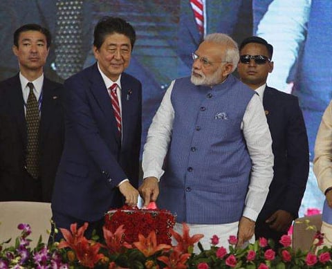 Japanese Prime Minister Shinzo Abe, center left and Indian Prime Minister Narendra Modi, center right, press a button to launch a high speed rail project in Ahmedabad on Thursday.