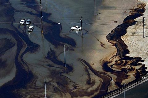 Vehicles sit amid leaked fuel mixed in with flood waters caused by Tropical Storm Harvey in the parking lot of Motiva Enterprises LLC in Port Arthur, Texas, U.S. on August 31, 2017. (Photo | Reuters)