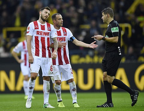 Cologne payers protest the referee's decision during their match against Borussia Dortmund. | AP