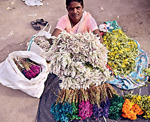 Woman sells Bathukamma flowers on the Day-1 of the nine day floral festival in Hyderabad on Wednesday |  Vinay Madapu