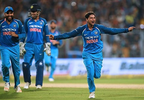 Kuldeep Yadav celebrates after completing his hat-trick during the second one day international(ODI) match of the ongoing India-Australia cricket series at the Eden Gardens Cricket Stadium in Kolkata.|AFP