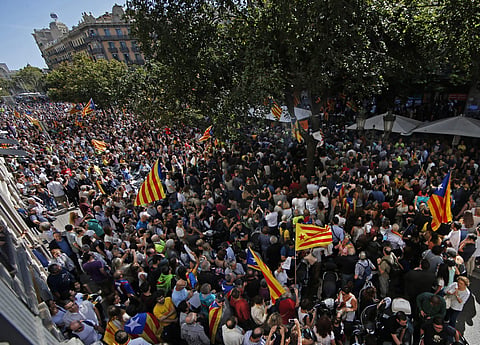 A crowd of pro-independence protestors gather outside the headquarters of the region's department of economic affairs in Barcelona. (Photo | AP)