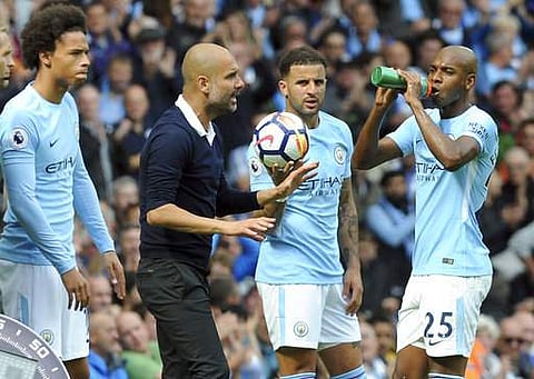 Manchester City's coach Pep Guardiola gestures as he talks to players during the EPL match against Liverpool at the Etihad Stadium in Manchester. | AP