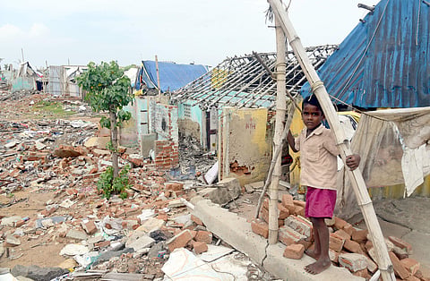 The houses that were already razed down at Nalla Thanni Odai (NTO) Kuppam. Trucks passing by the hamlet. (Martin Louis | EPS)