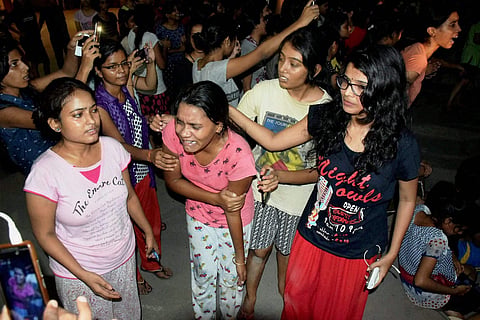 An injured student writhing in pain after police allegedly beat them up during a clash at Banaras Hindu University. (PTI)