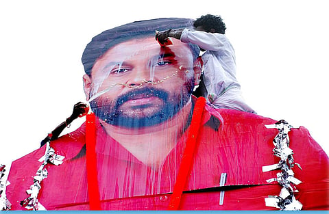 Fans anoint actor Dileep's cut out with milk  after the film show at Saritha Theatre in Kochi (EPS | K Shijith)