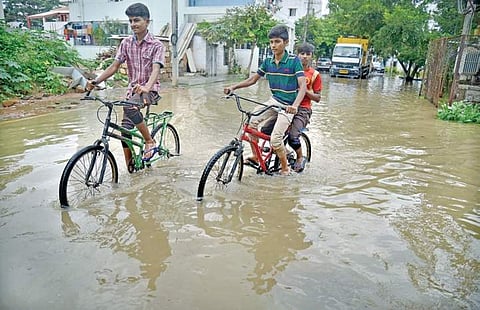 While most residents in HSR Layout stayed home on Saturday, these children decided to take a joyride on an inundated road | pushkar v