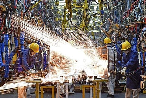 Employees work along a production line at a factory of Dongfeng Nissan Passenger Vehicle Co. in Zhengzhou, Henan province, China. (File Photo | Reuters)