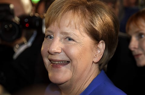 Angela Merkel smiles at a television studio after the live televised debate of German Chancellor Angela Merkel and Social Democrat Party chairman and challenger Martin Schulz in Berlin, Germany. | AP