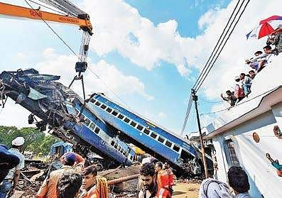 A coach of the Utkal Express train being hauled off the tracks by a crane, at the accident site in Muzaffarnagar.| PTI Photo
