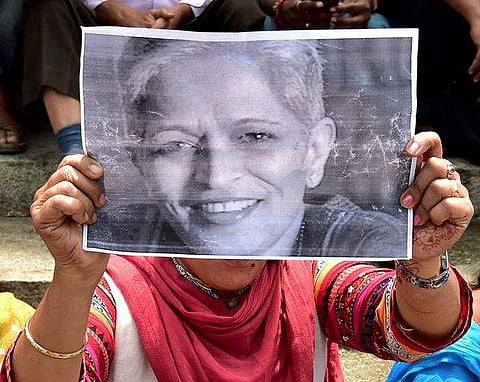A Protester holds up a picture of Gauri Lankesh | PTI