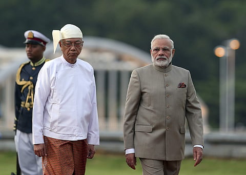 Myanmar's President Htin Kyaw, left, accompanies India Prime Minister Narendra Modi, right, as they inspect the honor guard during a welcome ceremony at the Presidential Palace in Naypyitaw, Myanmar, Tuesday, Sept 5, 2017. (AP Photo/Aung Shine Oo)