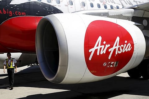 A member of ground staff walks under the wing of an AirAsia plane. (File | Reuters)