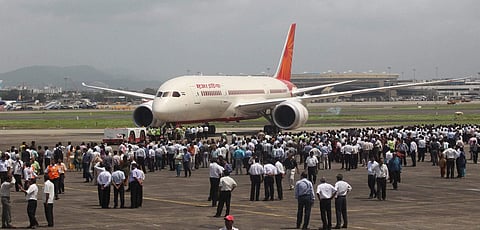 Air India employees gather around a newly acquired Air India B-787 Dreamliner aircraft after it landed at the airport in Mumbai in September 2012. | PTI