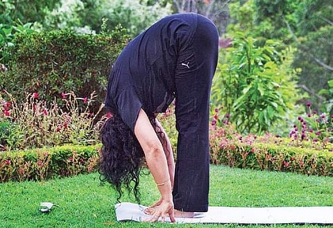 Trouble with bloating issues? Try this hands-to-feet stretch