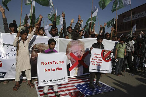 Pakistani protesters burn banners showing U.S. President Donald Trump in Hyderabad, Pakistan, Tuesday, Jan. 2, 2018. (Photo  | Associated Press)