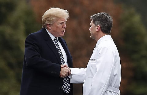 President Donald Trump shakes hands with White House physician Dr. Ronny Jackson. (Photo | AP)