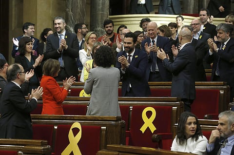 Deputy Roger Torrent (center) is congratulated after being elected as the new president of the Catalan parliament. (Photo | AP)