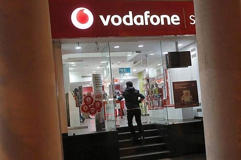 A customer enters a Vodafone store in New Delhi. | REUTERS