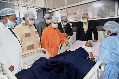 Uttar Pradesh Chief Minister Yogi Adityanath meets the injured Class I student at King George’s Medical University in Lucknow on Thursday | pti
