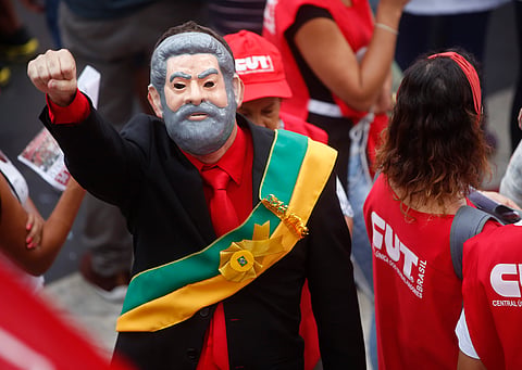 A demonstrators wearing a presidential sash and a mask depicting Brazil's former President Luiz Inacio Lula da Silva attend a protest in support of him and Brazil's President Dilma Rousseff, in Sao Paulo, Brazil, Thursday, March 31, 2016.
