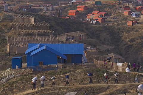 Rohingya refugee Muslims who were staying in no-man's land at Bandarban between Myanmar and Bangladesh border carry their belongings to new locations. (Photo | AP)