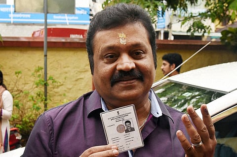 In this file image, actor and BJP MP Suresh Gopi shows voter ID and finger after casting vote for the assembly elections at a booth in Thiruvananthapuram. (File | PTI)