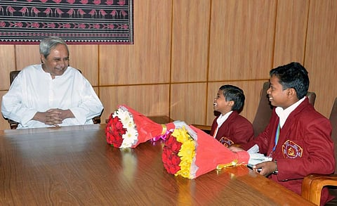 Odisha CM felicitating Mamata Dalai and Pankaj Mohanta, the two winners of the Bravery Award this year. (Twitter Photo | @Naveen_Odisha )