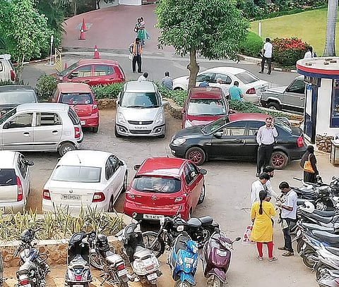 An attendant (right) of the paid parking lot at MMM collecting fee | Samuel Merigala