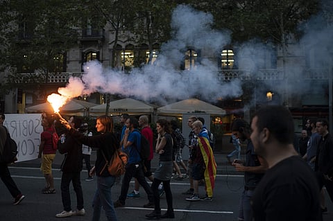 Activists advocating for Catalonia's secession from Spain blocked major highways, train lines and avenues across the northeastern region Monday, one year after a banned referendum crushed by police failed to deliver an independent state. ( Photo | AP)