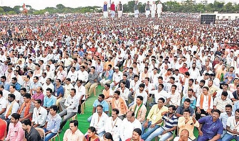 BJP president Amit Shah addresses a huge gathering during a public meeting at Ambedkar Stadium in Karimnagar on  Wednesday | Express