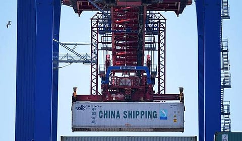 A container of China Shipping is loaded at a loading terminal in the port of Hamburg Germany July 27, 2018.  (Photo | Reuters)