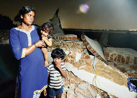 Hemavathi, with her two children, near her demolished house |  shiba prasad sahu